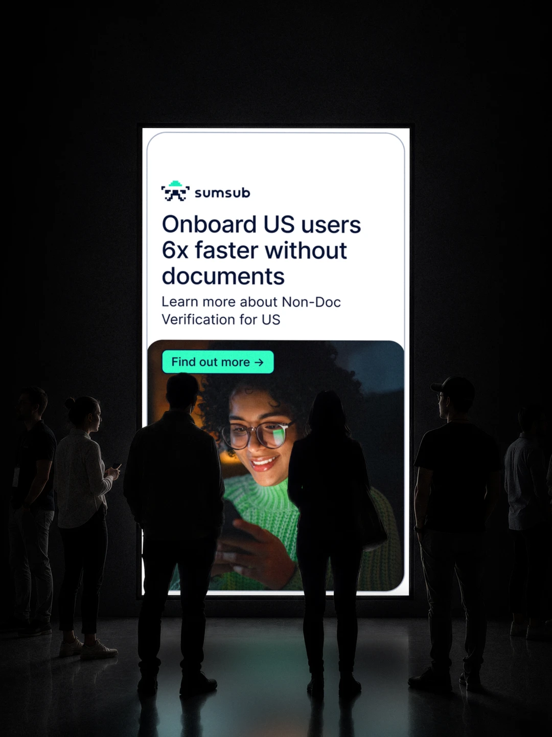 Dark exhibition wall with a large "Onboard US users 6x faster without documents" poster and silhouettes of visitors in front