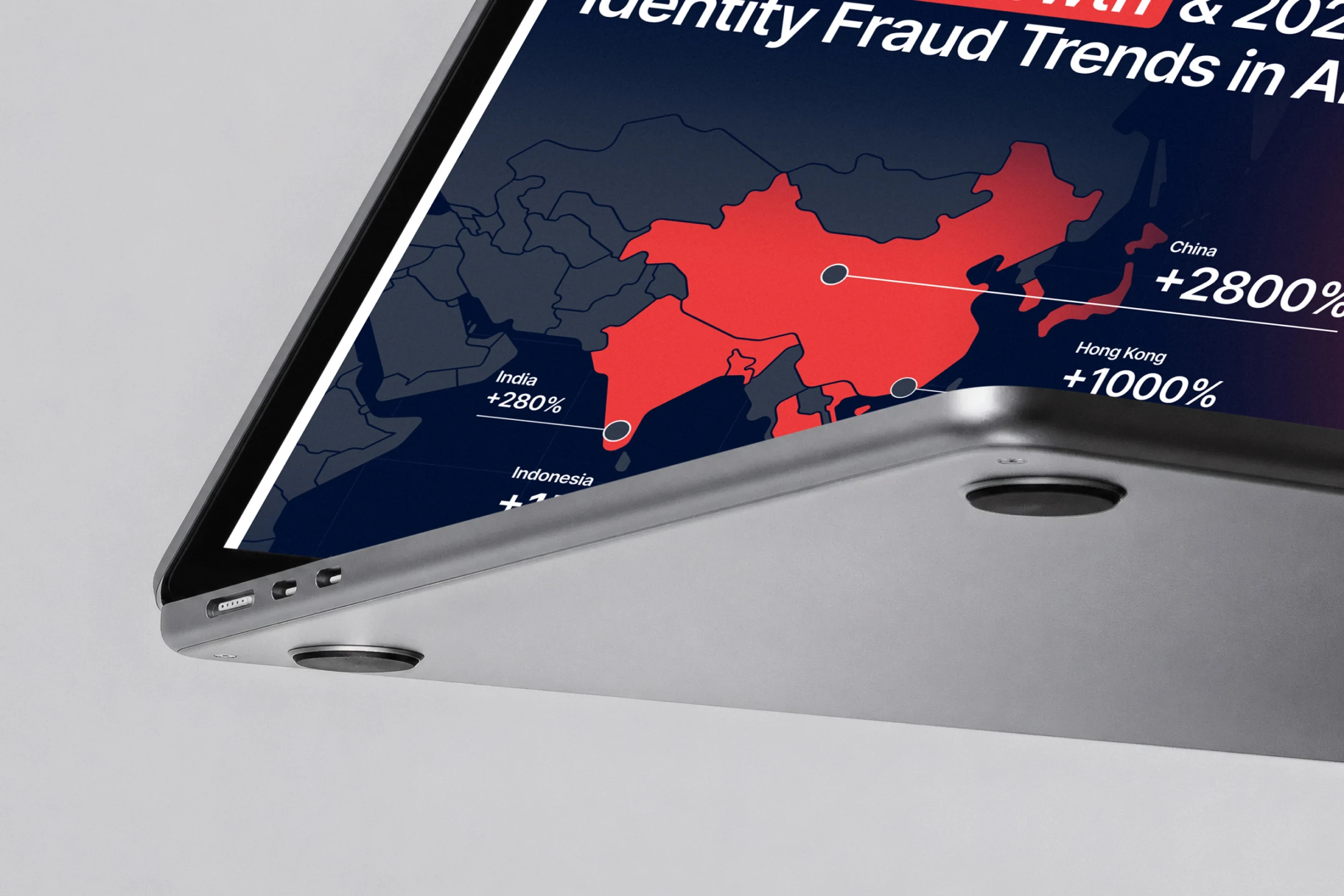 Close-up of a laptop edge showing a red heat map of Asia with "+2800%" and "+1000%" growth figures