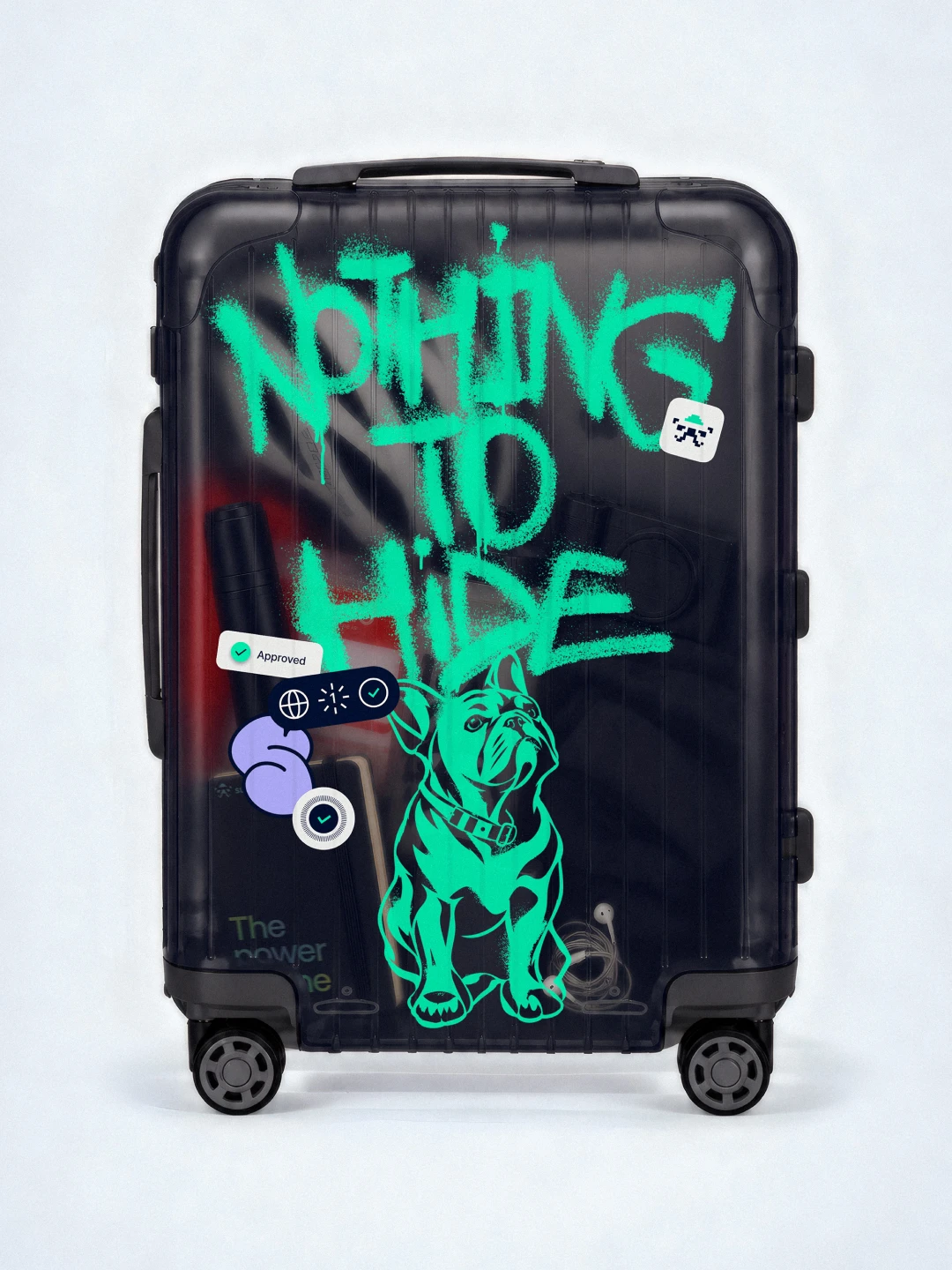 Dark hard-shell suitcase covered in mint spray graffiti reading "Nothing to hide"