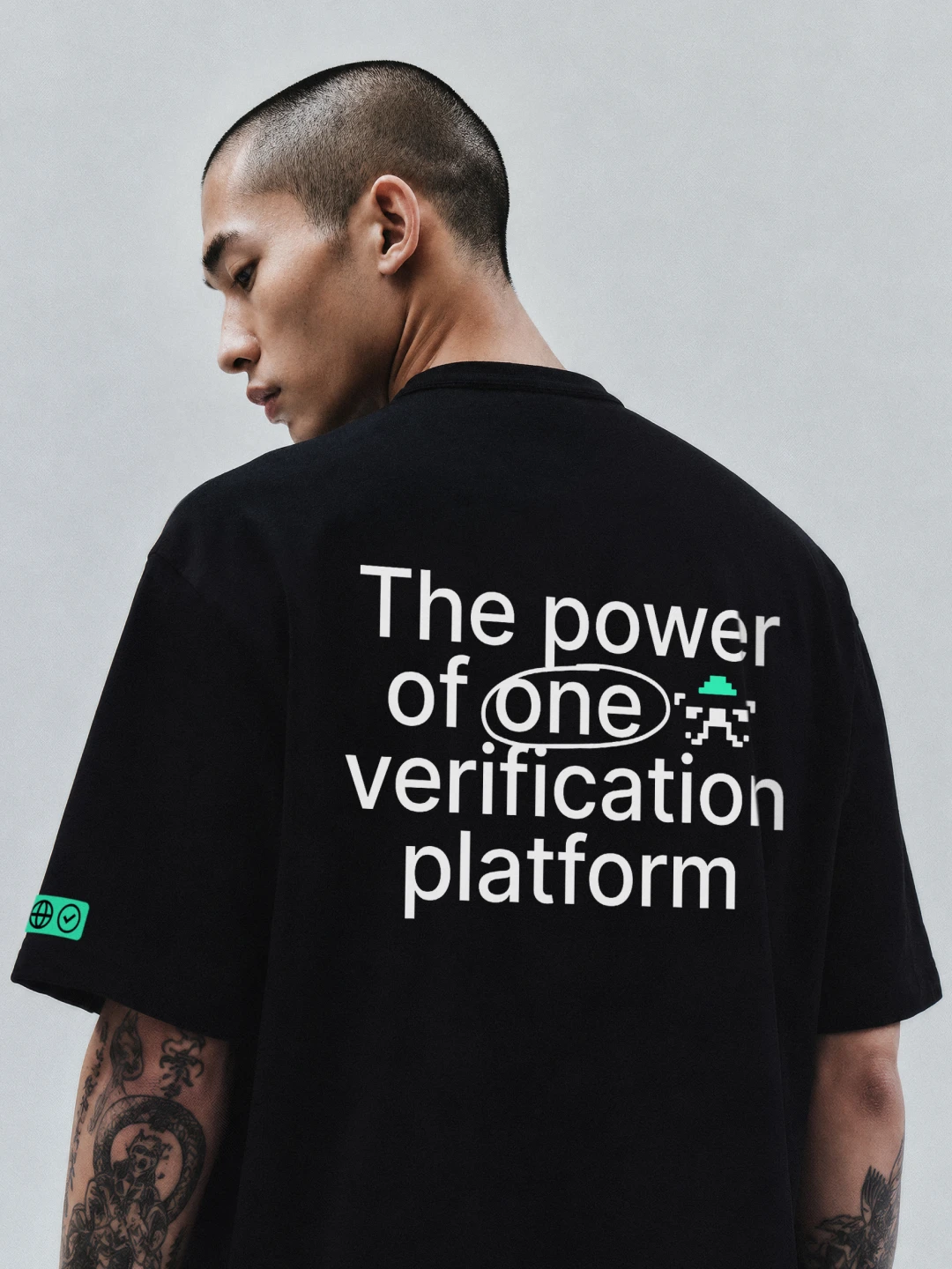 Man in a black T-shirt printed "The power of one verification platform"
